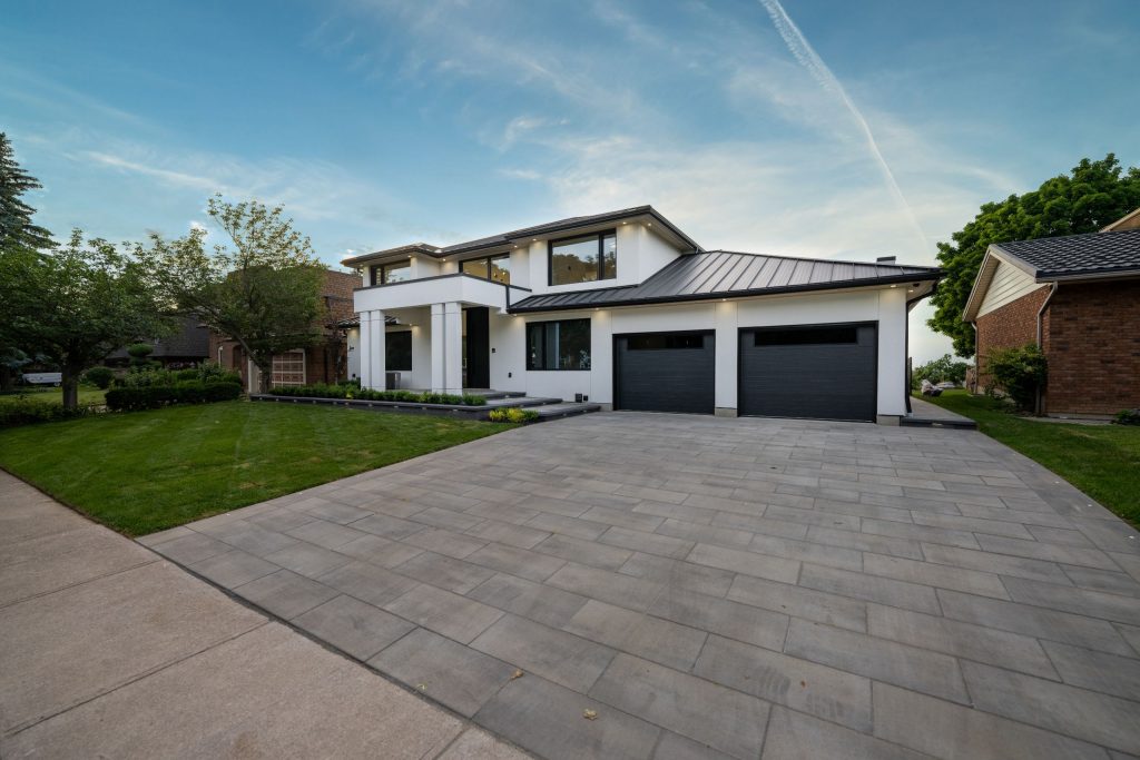 The driveway and front of a modern house.