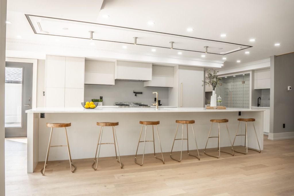 A modern kitchen with a large island and stools