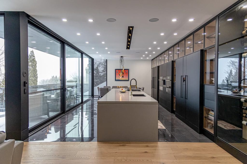 A long modern kitchen with huge floor to ceiling windows