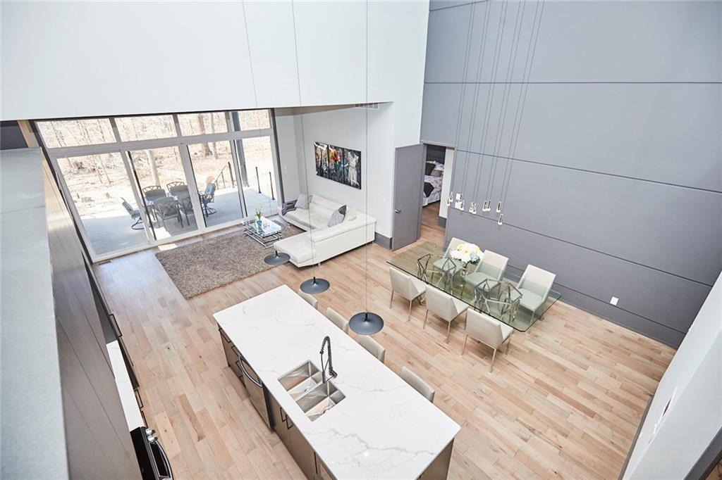 a top down view of a kitchen and dining room of a house.